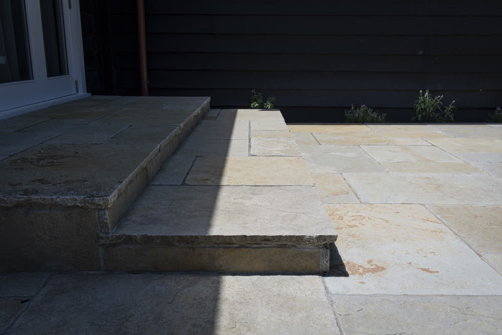 Paved patio with shallow steps to doorway